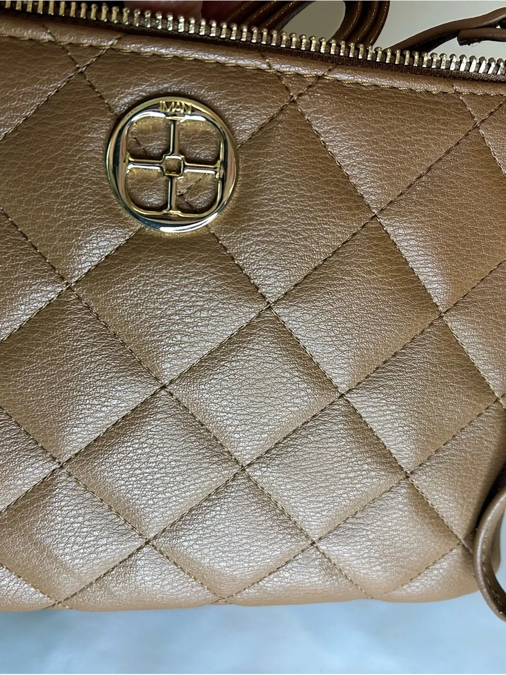 IMAN Quilted Tan Crossbody with Gold Medallion
